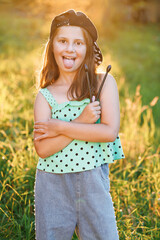 Portrait of smiling beautiful drummer girl crossed arms smiling at camera posing. Happy caucasian kid girl drummer. Girl playing on drum kit. Emotional portrait. Cheerful little girl playing drums.