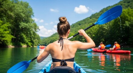 A strong, confident woman seen from behind, kayaking on a calm river surrounded by lush green mountains under a blue sky. Ideal for outdoor adventure, sport, and wellness themes.