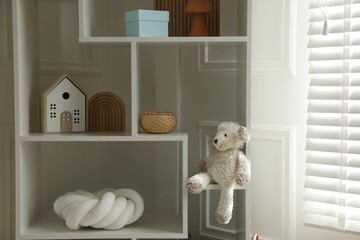 Stylish decor on shelves in playroom. Interior design