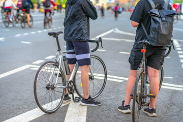 Cyclists. Two men in sportswear standing with bicycles on wide city street during urban cycling event. Concept of fitness, recreation, sport lifestyle