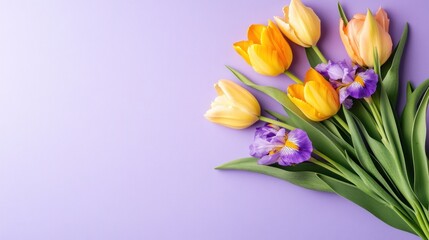 A bouquet of tulips and irises in pastel colors.