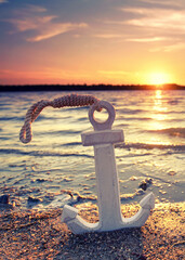 Timeless Anchor: A Weathered Wooden Relic at Sunset Shore