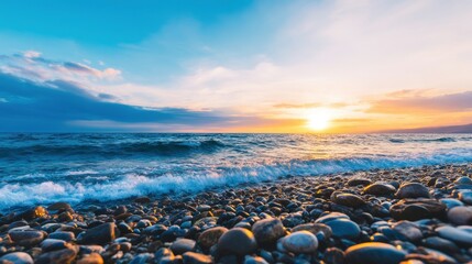 Serene sunset over a rocky beach with gentle waves lapping at the shore, creating a tranquil atmosphere