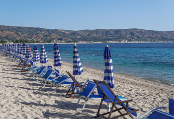 Limited beach access during the season, coastal safety measures or emergency preparedness measures. Closed beach umbrellas and absence of people indicate a ban on swimming.
