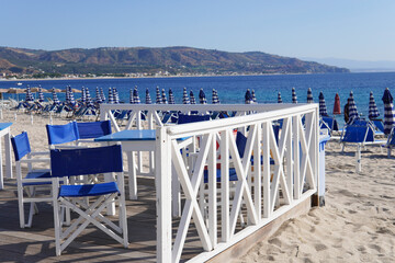 Limited beach access during the season, coastal safety measures or emergency preparedness measures. Closed beach umbrellas and absence of people indicate a ban on swimming.