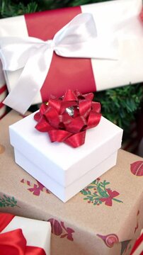 Vertical Under a modern Christmas tree, elegantly wrapped gift boxes enhance the holiday ambiance in a home, alongside holiday Xmas ornaments, as a design element for New Year decor. 