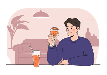 A man enjoys a refreshing drink in a cozy interior. Soft lighting and a relaxed pose create a pleasant atmosphere. Perfect for lifestyle and wellness visuals.
