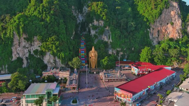 Kuala Lumpur, Malaysia: Aerial drone view of capital city of Malaysia, famous Batu Caves at sunset - landscape panorama of Southeast Asia from above
