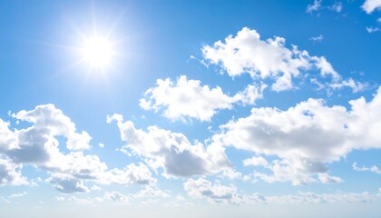 Bright sun shining through scattered clouds in a vast blue sky