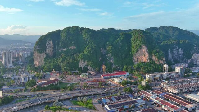 Kuala Lumpur, Malaysia: Aerial drone view of capital city of Malaysia, famous Batu Caves at sunset - landscape panorama of Southeast Asia from above
