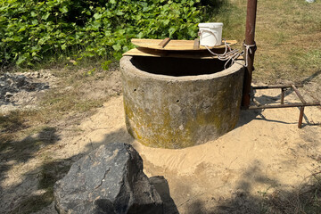 A mine well with concrete rings. Topped with white sand for protection and filtration.