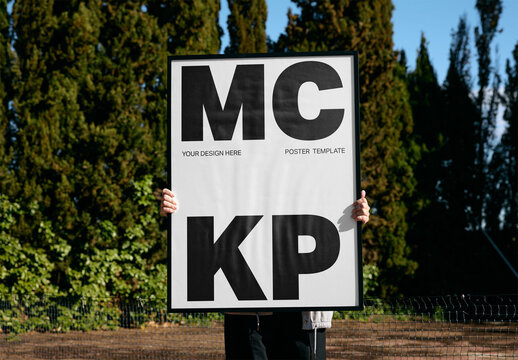Mockup Of Man Holding Vertical Customized Framed Poster Over Face
