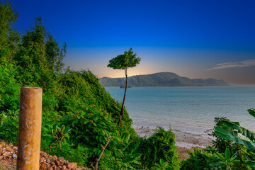 Beautiful view from Kao Khad next to Cape Panwa on the island of Phuket Thailand. Views of the turquoise Blue waters of the Andaman Sea and small islands off the coat of Phuket