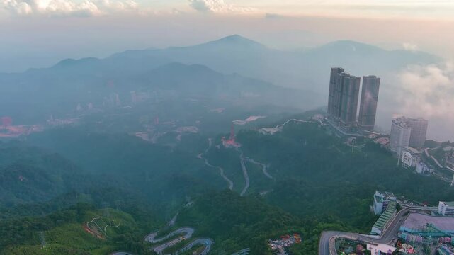 Genting Highlands, Malaysia: Aerial drone view of famous Genting Highlands in clouds at sunset - landscape panorama of Southeast Asia from above
