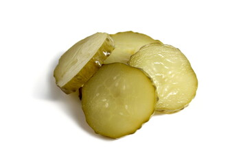 Pieces of pickled cucumber lie on a white background.	