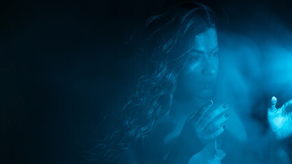 To touch the mystery, the concept. Portrait of a beautiful woman looking with interest at the...