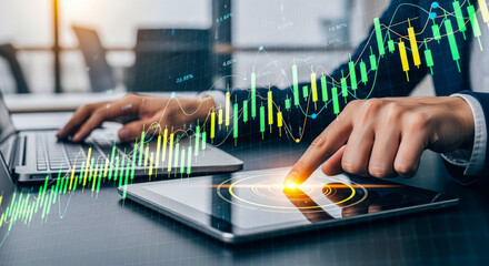 Businessman working on a laptop and tablet, with a vibrant holographic financial chart overlay featuring candlestick patterns and growth graphs, representing data analysis