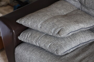 Close-up of three pillows on a couch