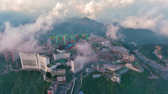 Genting Highlands, Malaysia: Aerial drone view of famous Genting Highlands in clouds at sunset - landscape panorama of Southeast Asia from above
