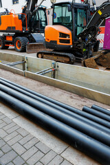 New modern insulated urban pipeline installation construction site  exposed underground pipes in...
