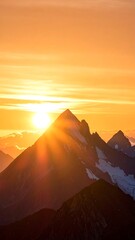 Sunrise over mountain peaks, golden light