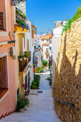 Alicante old town Santa Cruz with narrow street, typical white houses, traditional colorful buildings, Casco Antiguo Santa Cruz quarter in Alicante city historical centre, Valencian Community, Spain
