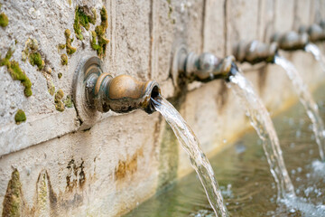 Water flowing from historic fountains in Brihuega, Guadalajara, showcasing the charm of Castilla-La...