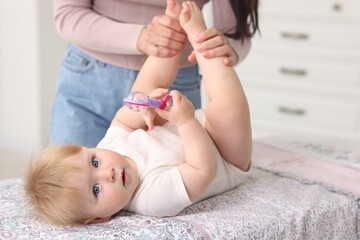 Mother with her cute baby at home, closeup