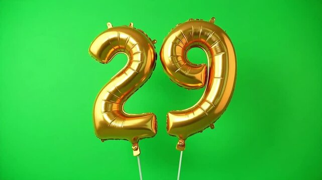 Golden balloons forming number twenty nine on a green backdrop convey celebration, milestone birthday or anniversary themes.