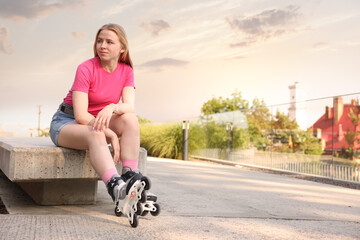 Happy woman with roller skates on street. Space for text