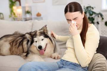 Woman suffering from allergy with her dog at home