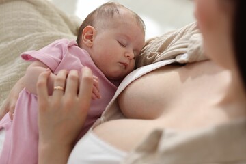 Mother with her newborn baby indoors, above view