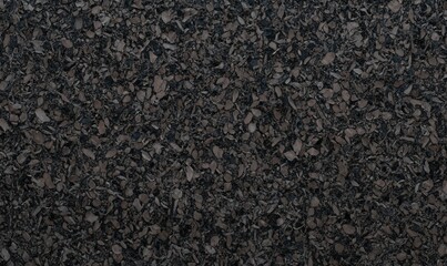 Dark brown cork texture with fine shredded granules, creating a rich and natural background. Perfect for eco-themed designs, sustainable materials, or realistic texture overlays.