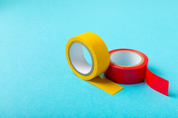 Insulating tape on a bright colored background. Set of different colors insulating tape. Reel...