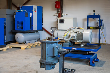 Screw compressor being repaired in industrial workshop