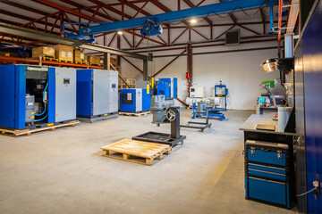 Industrial compressors and equipment in a warehouse setting