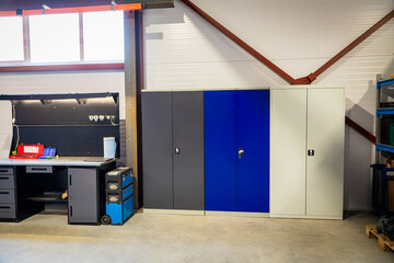 Modern workshop interior showing cabinets, workbench and tools