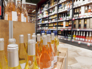 defocused alcohol (wine, champagne, liquor, whiskey) on store shelves