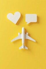 Fototapeta premium Creative composition of airplane, heart, and speech bubble on yellow background