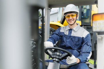 Portrait Young Caucasian male worker operating machinery at industrial site