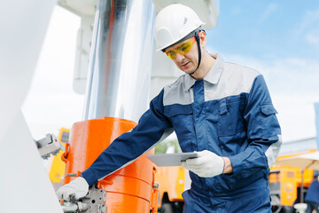 Hydraulic engineer doing safety check on new installation hoses pneumatic piston of industrial...