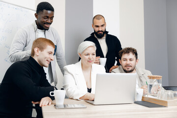 Diverse Business Team Collaborating on Project in Modern Office