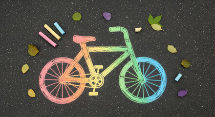 Colorful Chalk Bicycle Artwork On Asphalt Surrounded By Leaves And Chalk Sticks