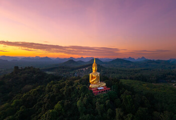 Sunset panorama Gold Big Buddha in Thailand. Aerial top view Wat Khao Chedi Wisai Tri Rattanaram...