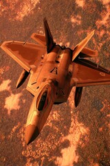 High-angle view of a fighter jet soaring above a fiery landscape.