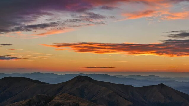 Majestic mountain range under dramatic sky: A beautiful sunset landscape nature scene for travel videos