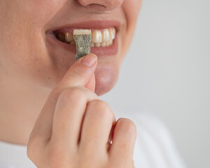 Woman Chewing Nicotine Snus Product. 