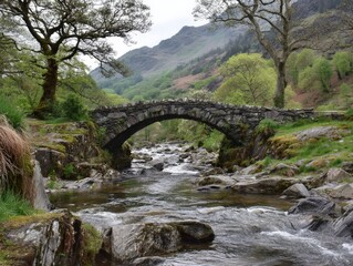 Stone arch bridge over a flowing river, nestled in a lush green valley.