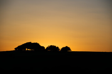 Hill in silhouette at sunset