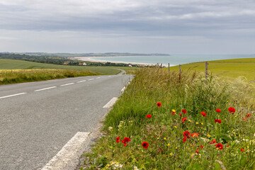 Road along Opal coast with sea view and little village with white houses in Northern France